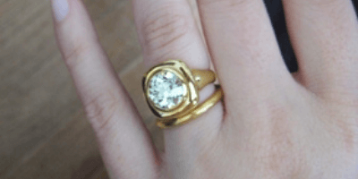 3 carat M color diamond yellow gold setting on hand
